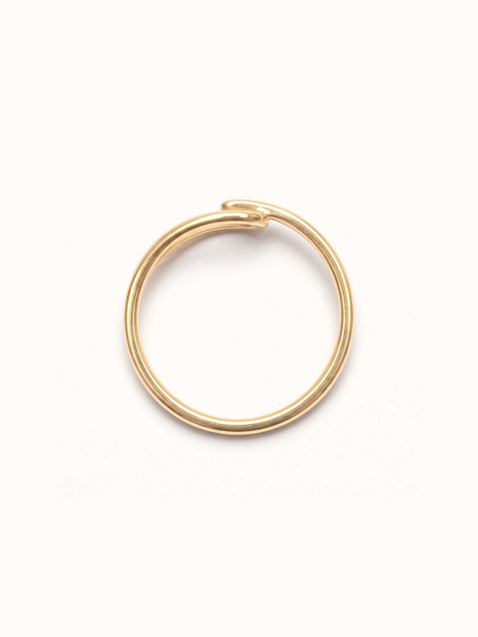 Held Ring – side view, gold, on ivory background