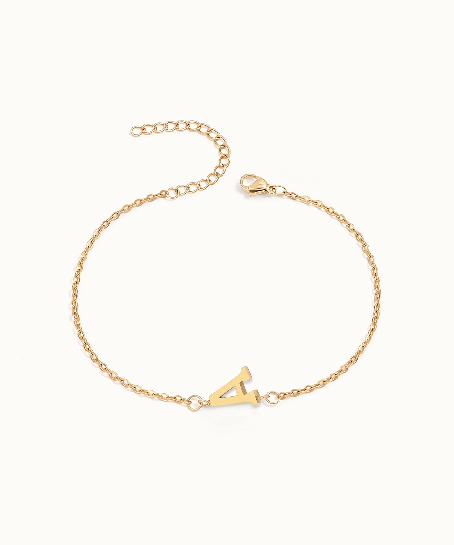 Initial Bracelet – letter A charm on a fine cable chain, gold, on ivory background