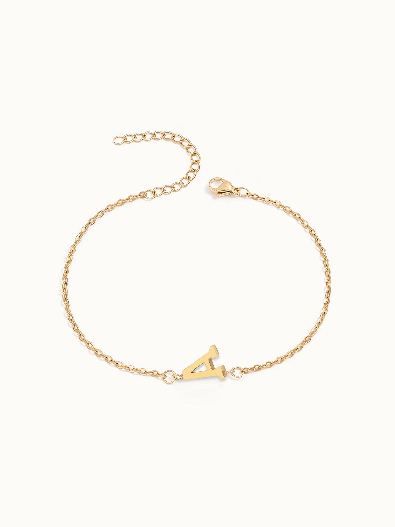 Initial Bracelet – letter A charm on a fine cable chain, gold, on ivory background