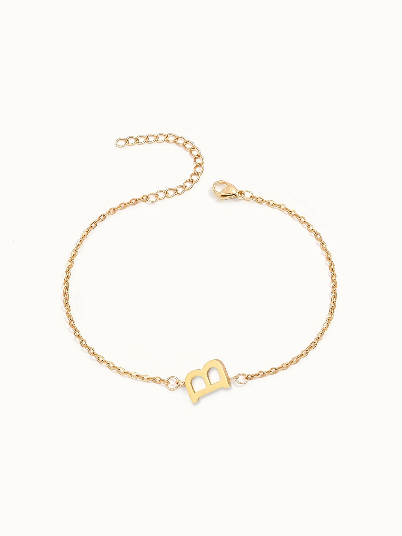 Initial Bracelet – letter B charm on a fine cable chain, gold, on ivory background