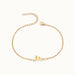 Initial Bracelet – letter F charm on a fine cable chain, gold, on ivory background