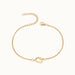 Initial Bracelet – letter G charm on a fine cable chain, gold, on ivory background