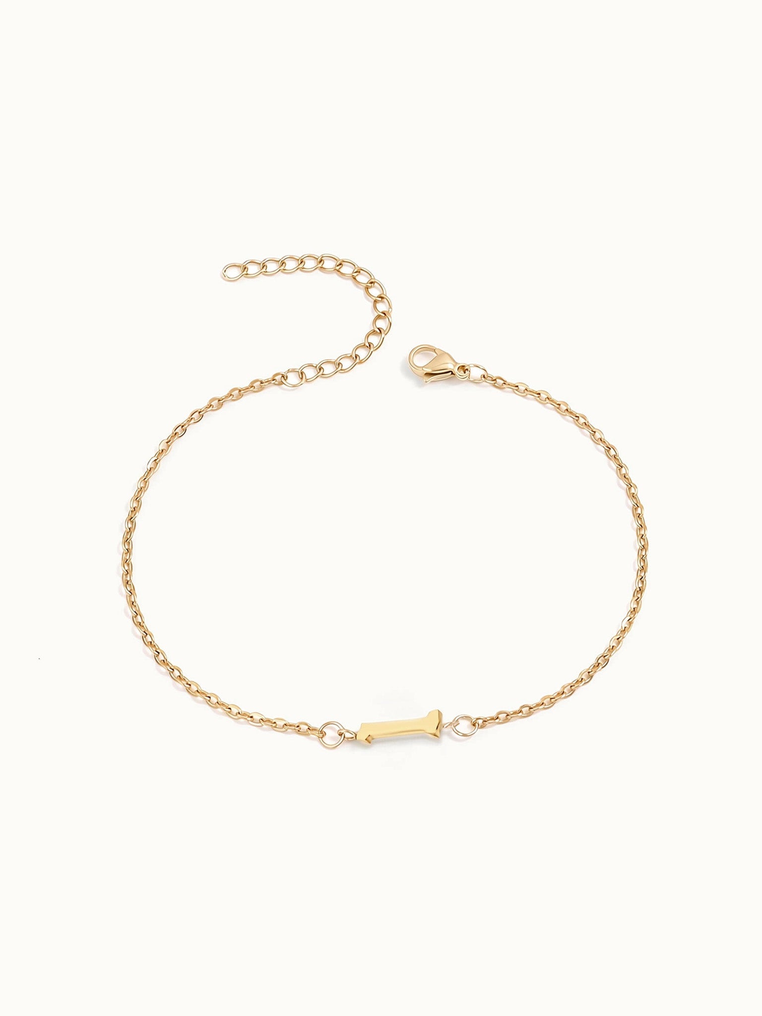 Initial Bracelet – letter I charm on a fine cable chain, gold, on ivory background