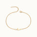 Initial Bracelet – letter J charm on a fine cable chain, gold, on ivory background