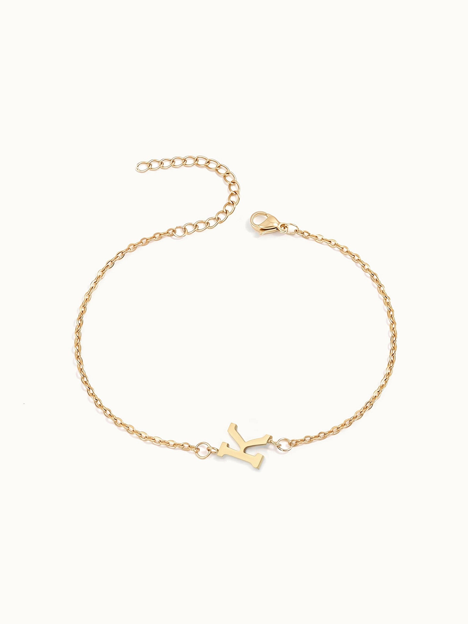 Initial Bracelet – letter K charm on a fine cable chain, gold, on ivory background