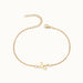 Initial Bracelet – letter K charm on a fine cable chain, gold, on ivory background