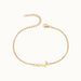 Initial Bracelet – letter L charm on a fine cable chain, gold, on ivory background