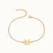 Initial Bracelet – letter M charm on a fine cable chain, gold, on ivory background