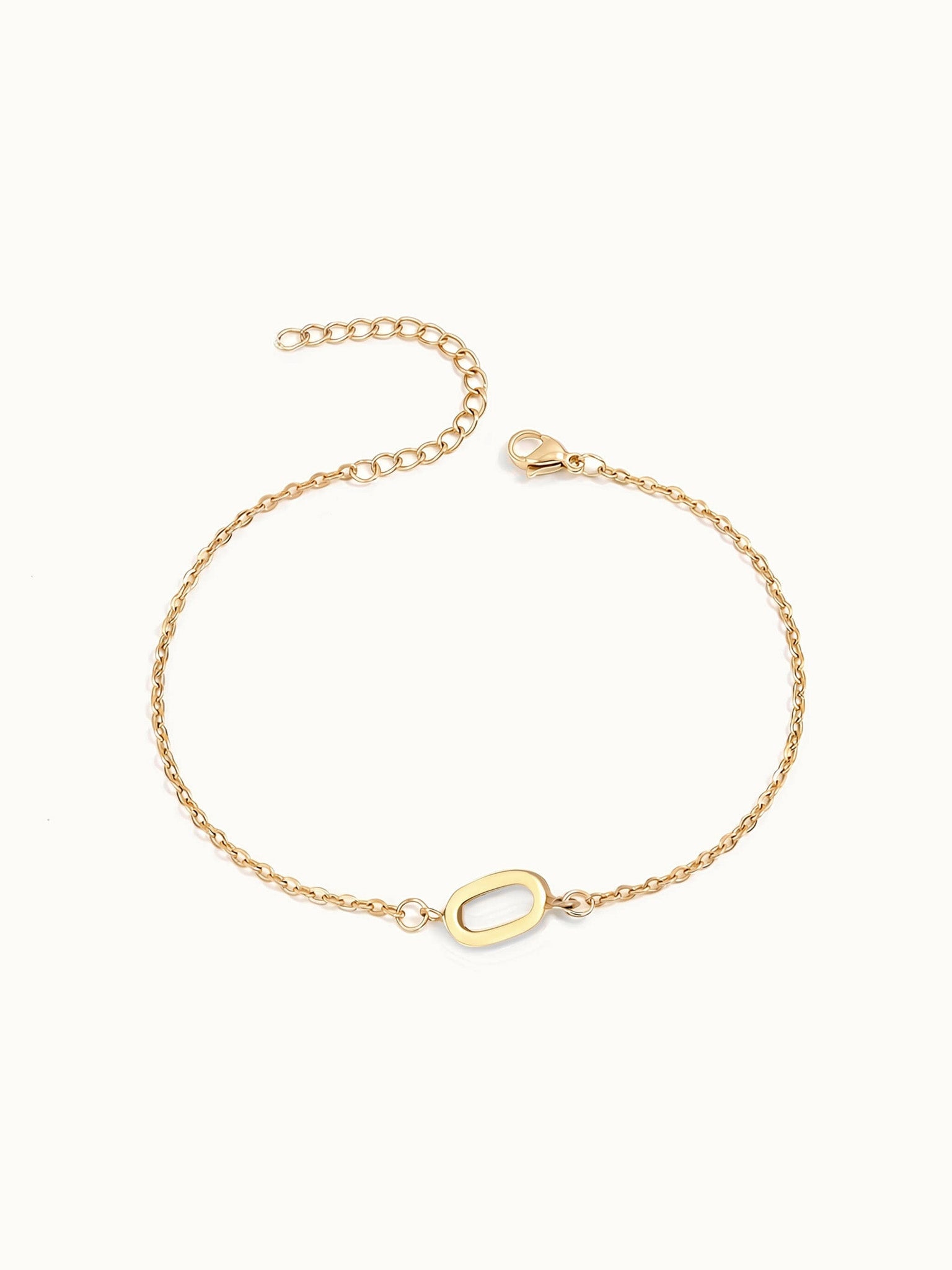 Initial Bracelet – letter O charm on a fine cable chain, gold, on ivory background