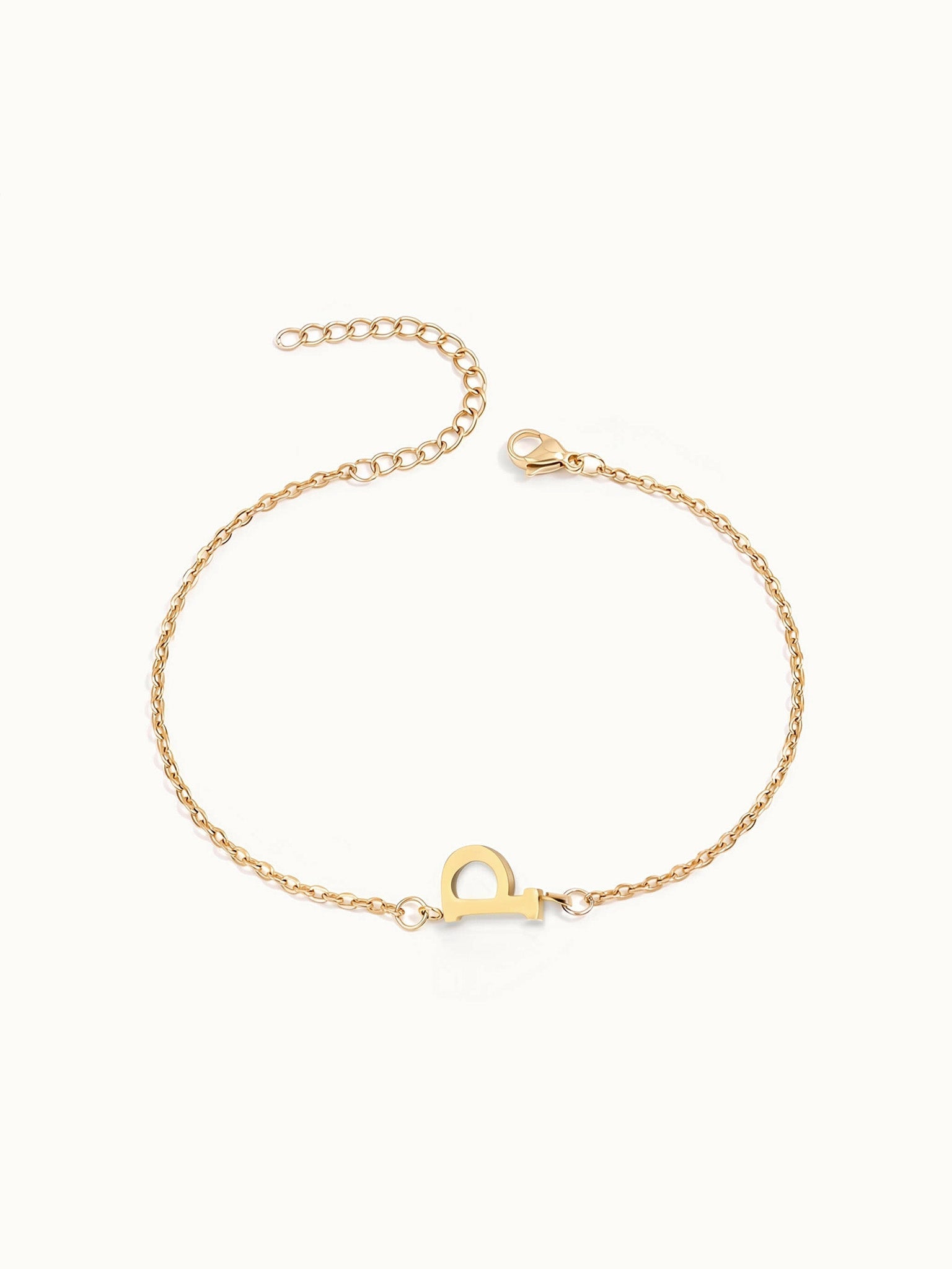 Initial Bracelet – letter P charm on a fine cable chain, gold, on ivory background