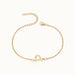 Initial Bracelet – letter P charm on a fine cable chain, gold, on ivory background