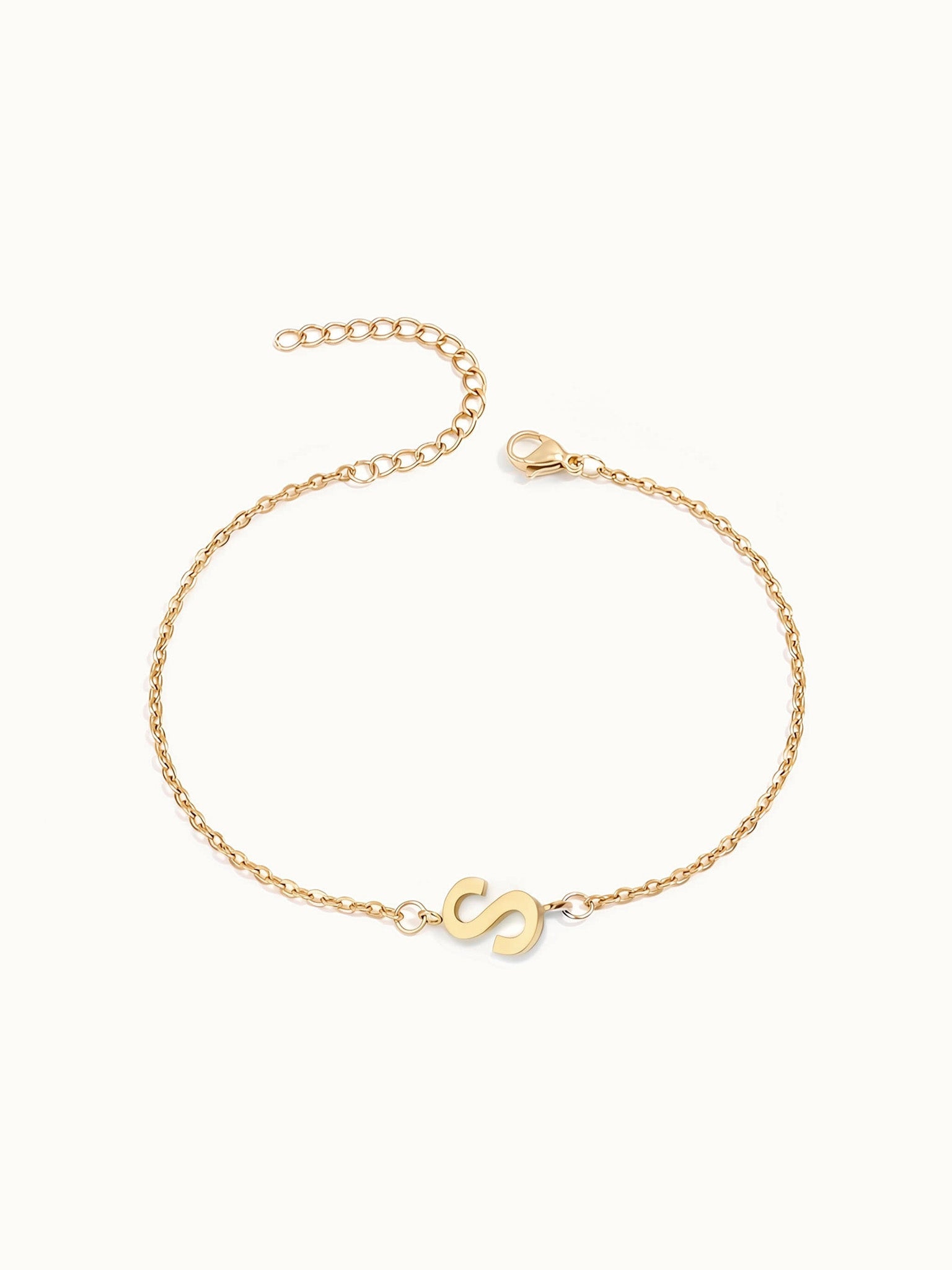 Initial Bracelet – letter S charm on a fine cable chain, gold, on ivory background