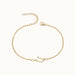 Initial Bracelet – letter U charm on a fine cable chain, gold, on ivory background