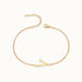 Initial Bracelet – letter V charm on a fine cable chain, gold, on ivory background