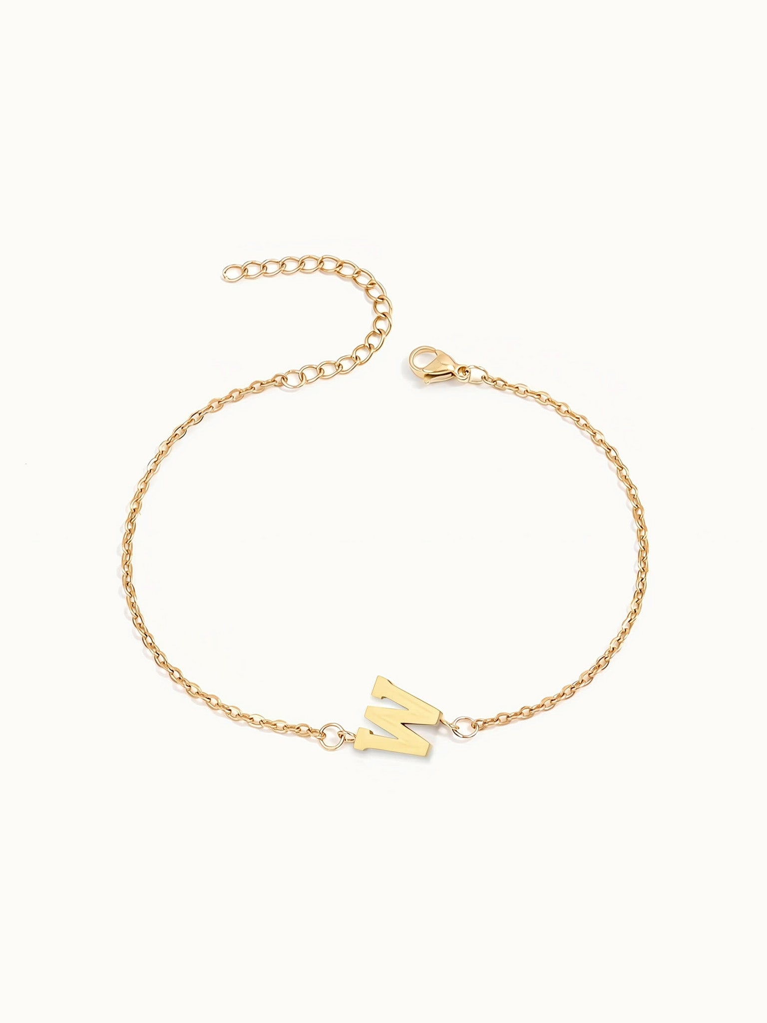 Initial Bracelet – letter W charm on a fine cable chain, gold, on ivory background