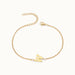 Initial Bracelet – letter W charm on a fine cable chain, gold, on ivory background