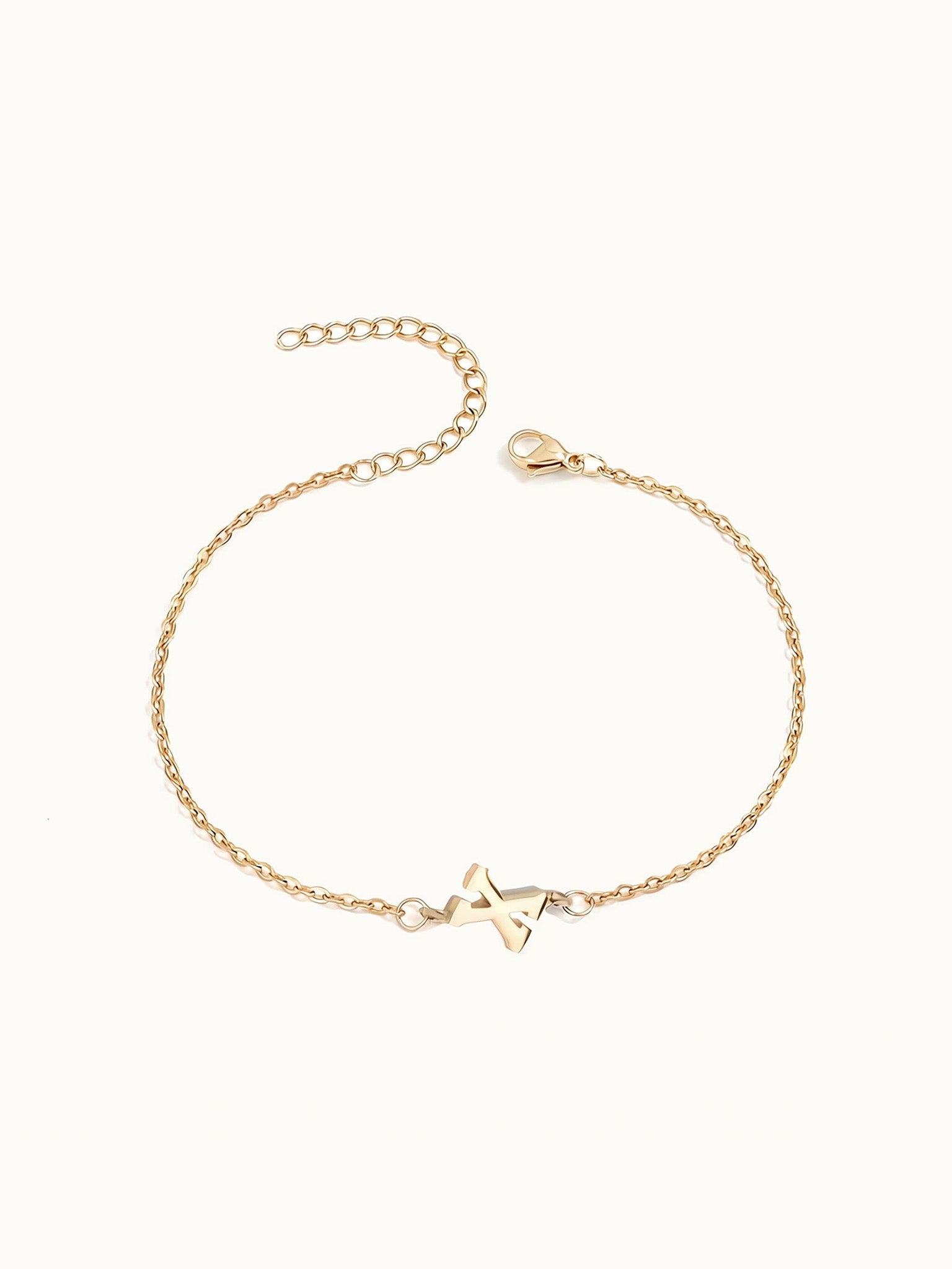 Initial Bracelet – letter X charm on a fine cable chain, gold, on ivory background
