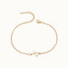 Initial Bracelet – letter X charm on a fine cable chain, gold, on ivory background