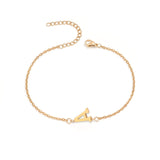 Initial Bracelet in gold with letter A charm, flat lay on white background