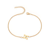 Initial Bracelet in gold with letter H charm, flat lay on white background