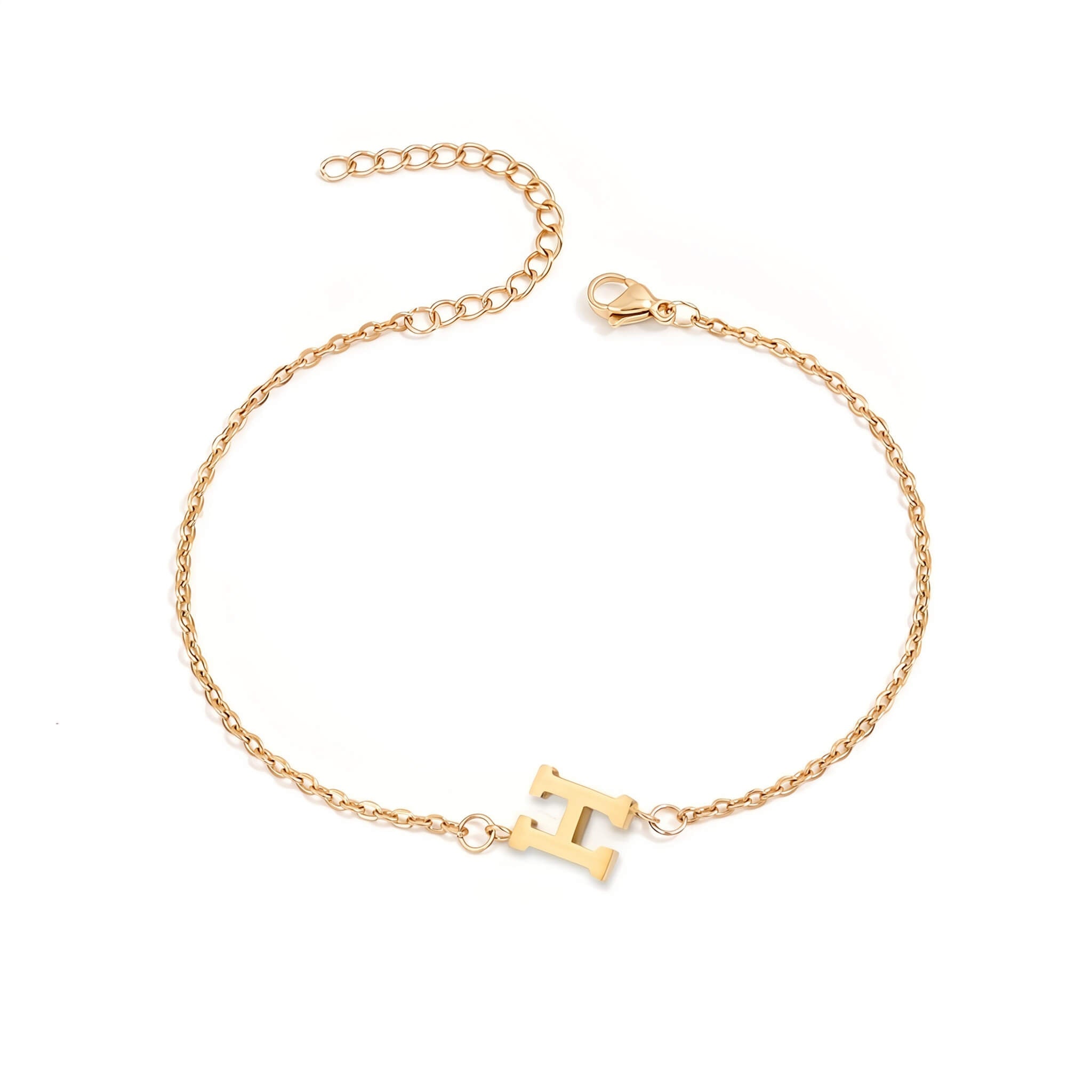 Initial Bracelet in gold with letter H charm, flat lay on white background