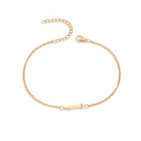 Initial Bracelet in gold with letter I charm, flat lay on white background