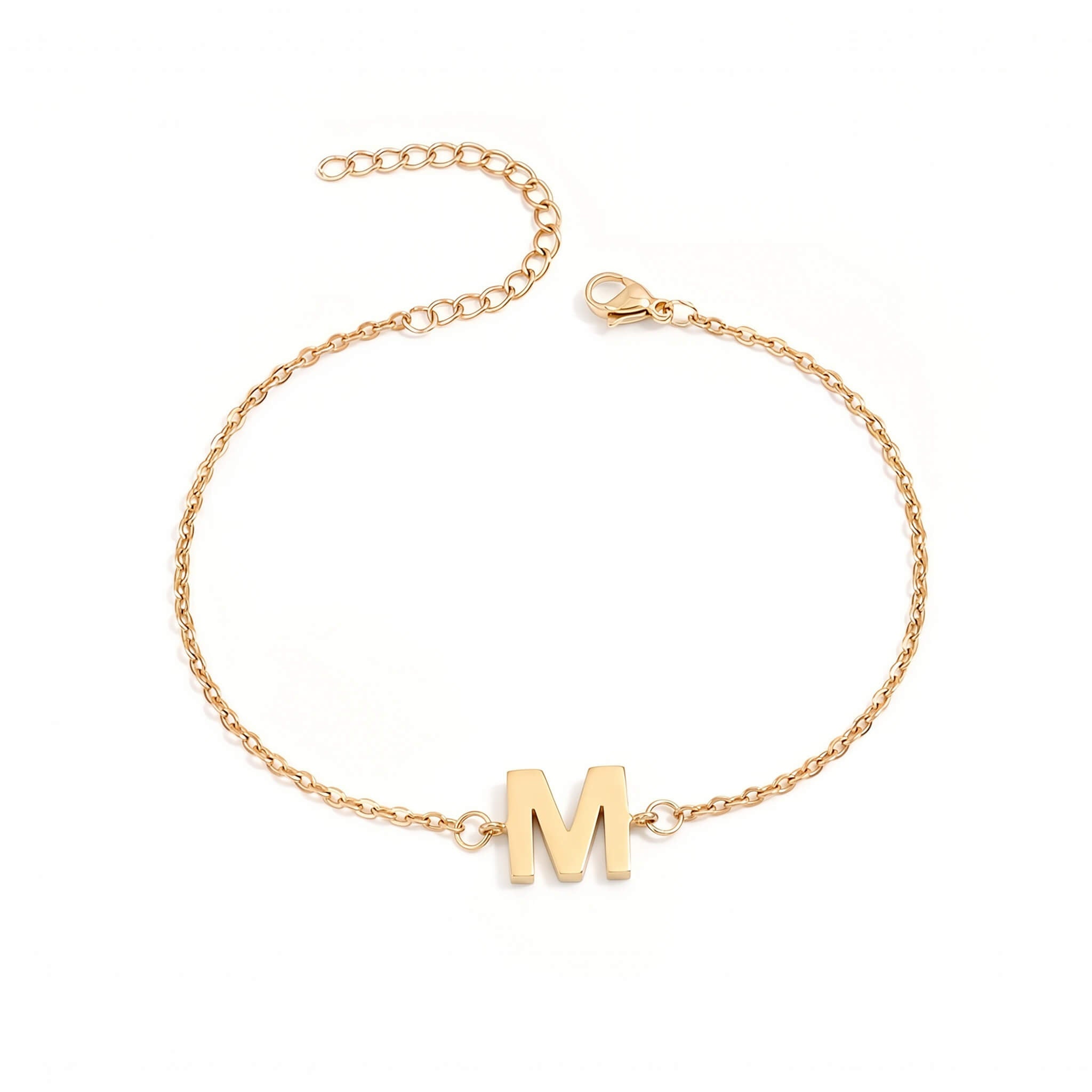 Initial Bracelet in gold with letter M charm, flat lay on white background