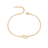 Initial Bracelet in gold with letter S charm, flat lay on white background