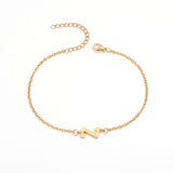 Initial Bracelet in gold with letter Z charm, flat lay on white background