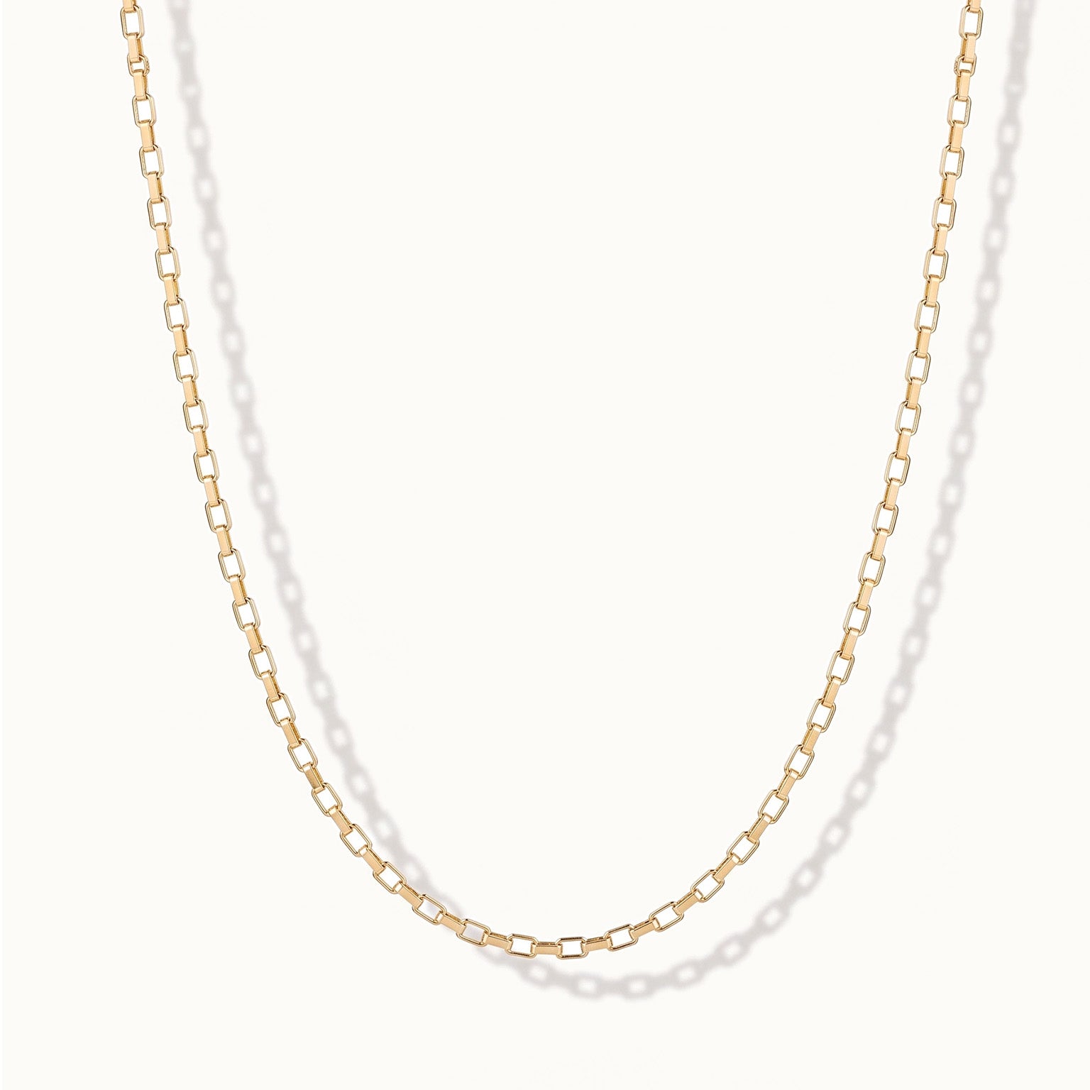 Kindred Link Necklace – link chain hanging in a U, gold, on ivory background