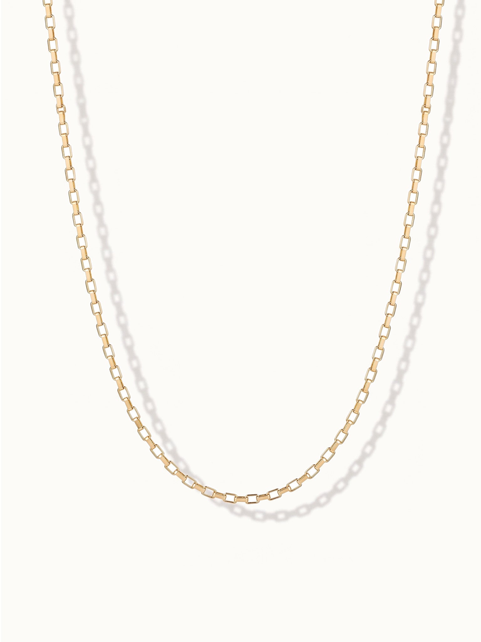 Kindred Link Necklace – link chain hanging in a U, gold, on ivory background