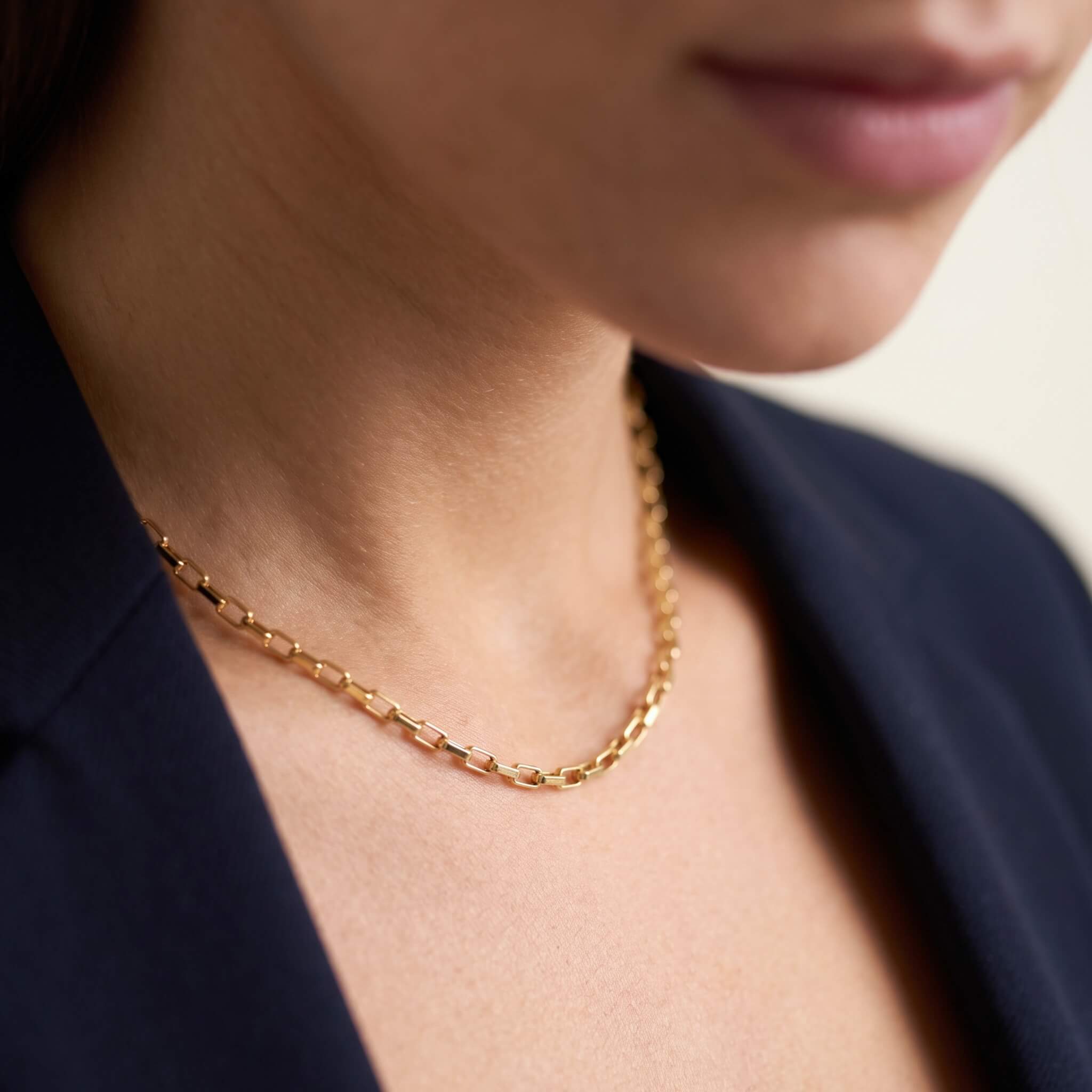 Kindred Link Necklace – worn at the collarbone, gold, navy blazer