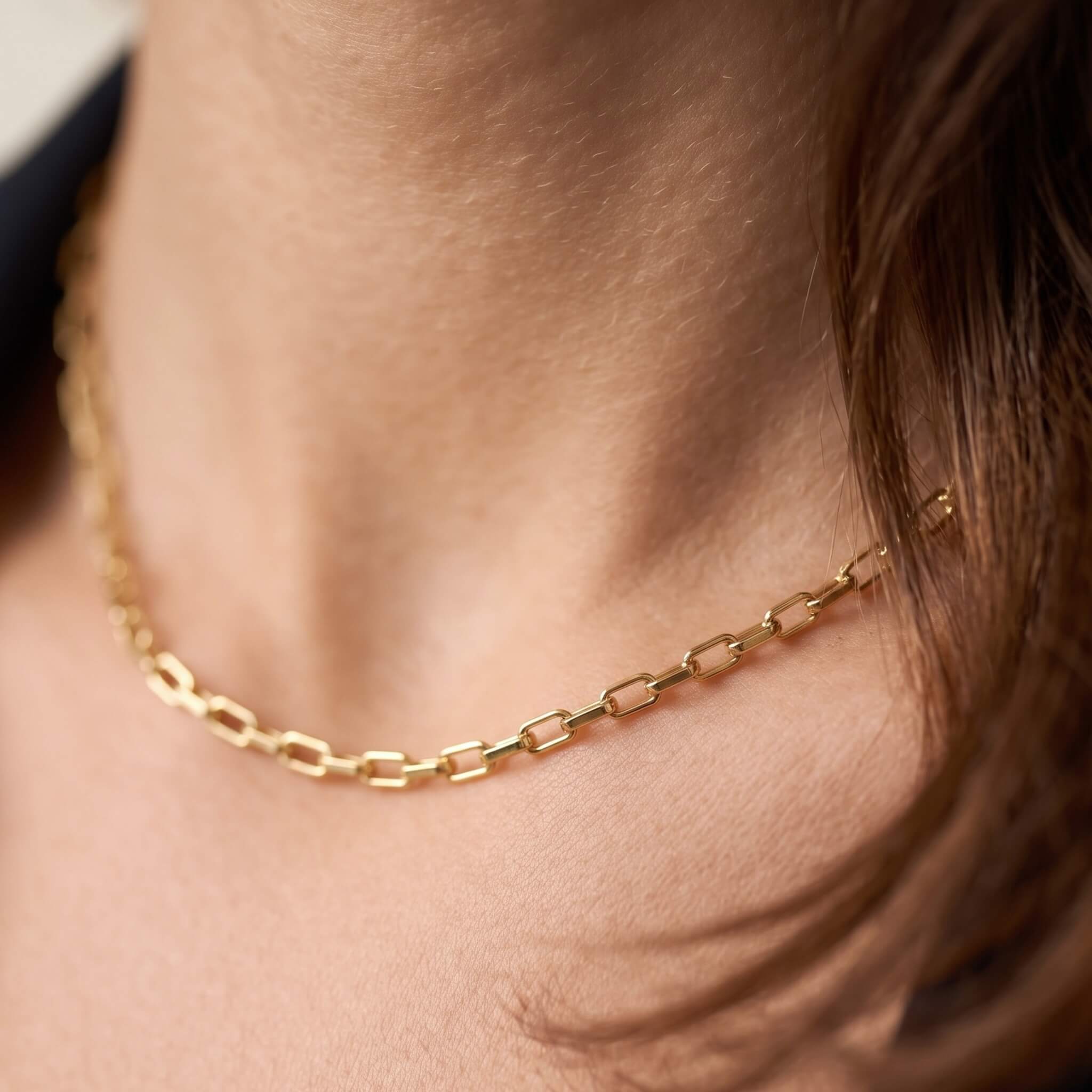Kindred Link Necklace – worn at the base of the neck, close-up, gold, hair falling to one side