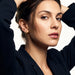 Morning Joy Studs – worn in the ear, both hands in the hair, looking at the camera, gold teardrop stud, dark hair up