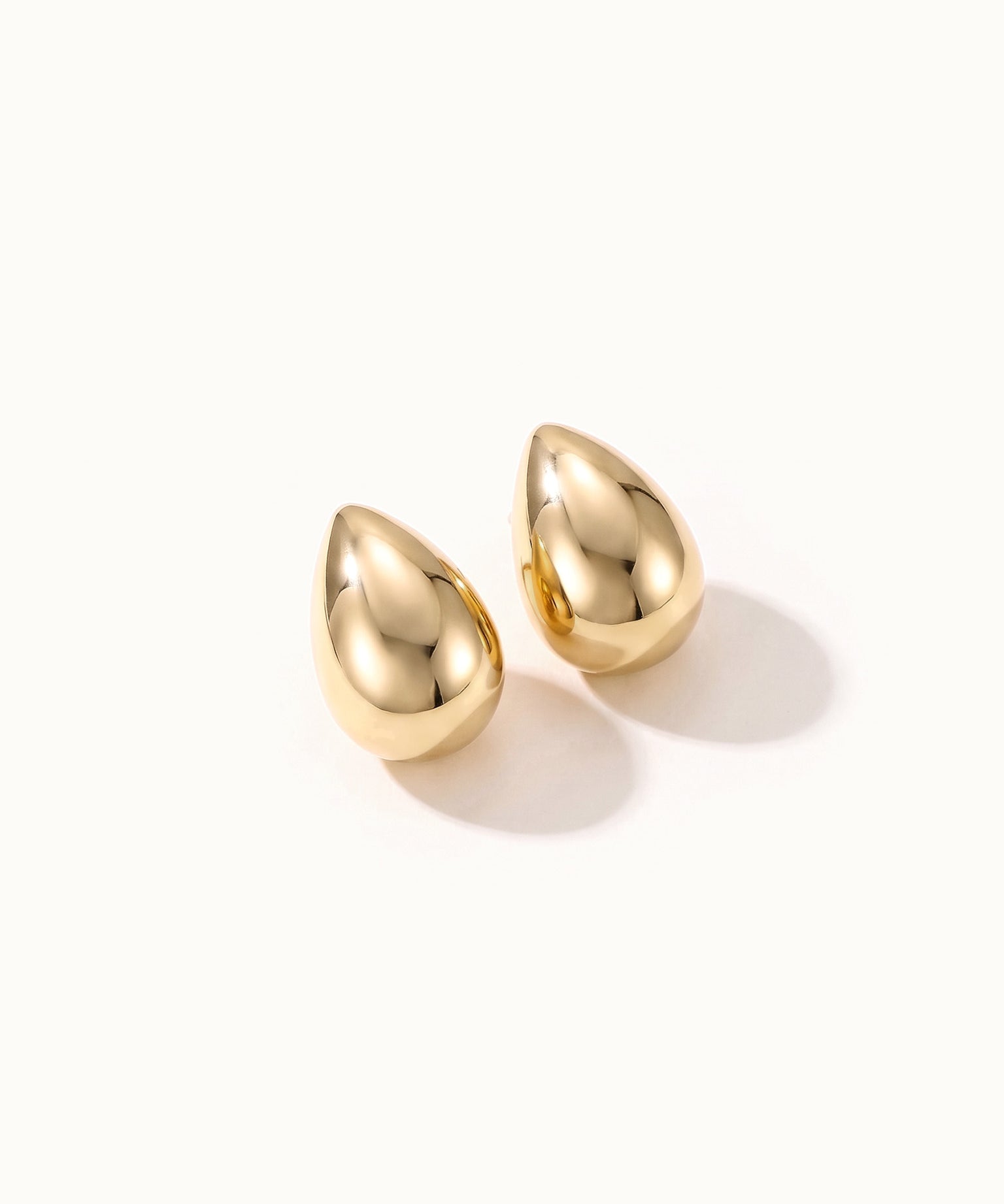 Morning Joy Studs – pair of teardrop studs, gold, on ivory background