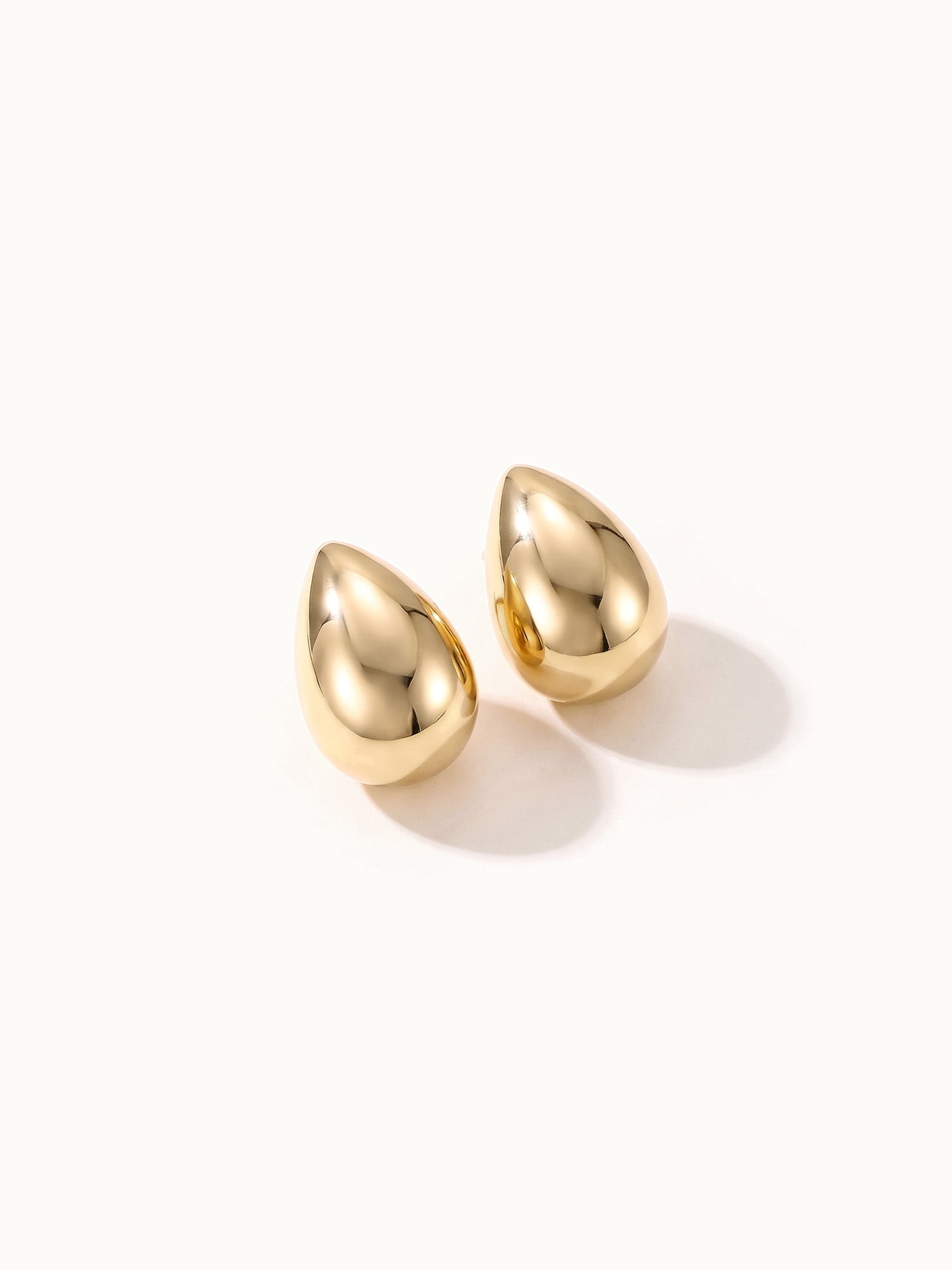 Morning Joy Studs – pair of teardrop studs, gold, on ivory background