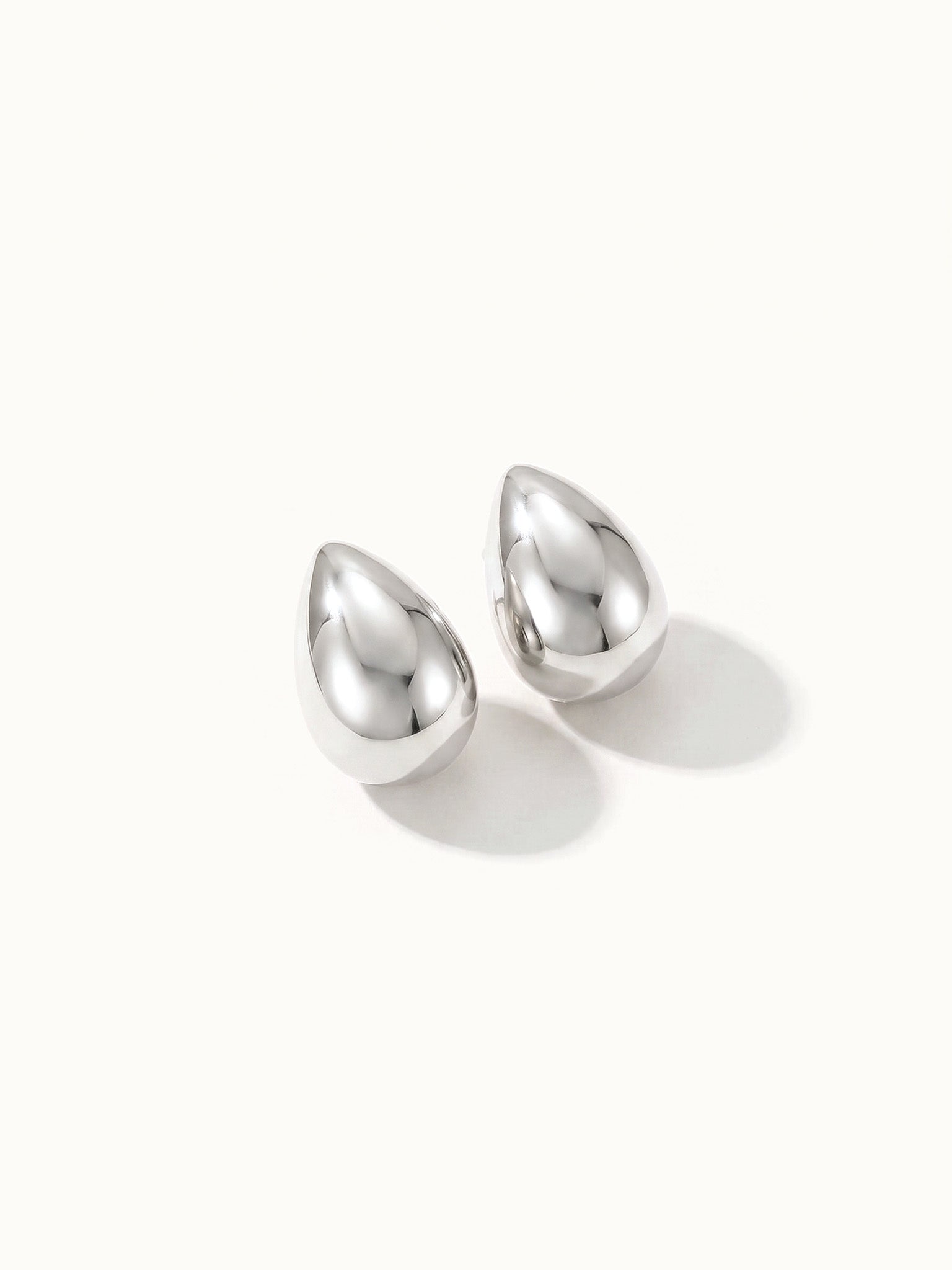 Morning Joy Studs – pair of teardrop studs, silver, on ivory background