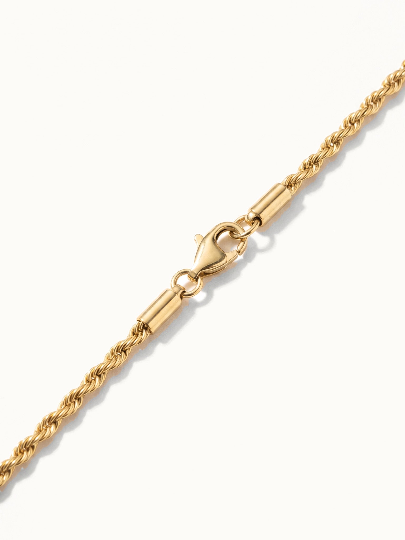 Morning Light Twist Bracelet – close-up of the clasp and twisted rope chain, gold, on ivory background