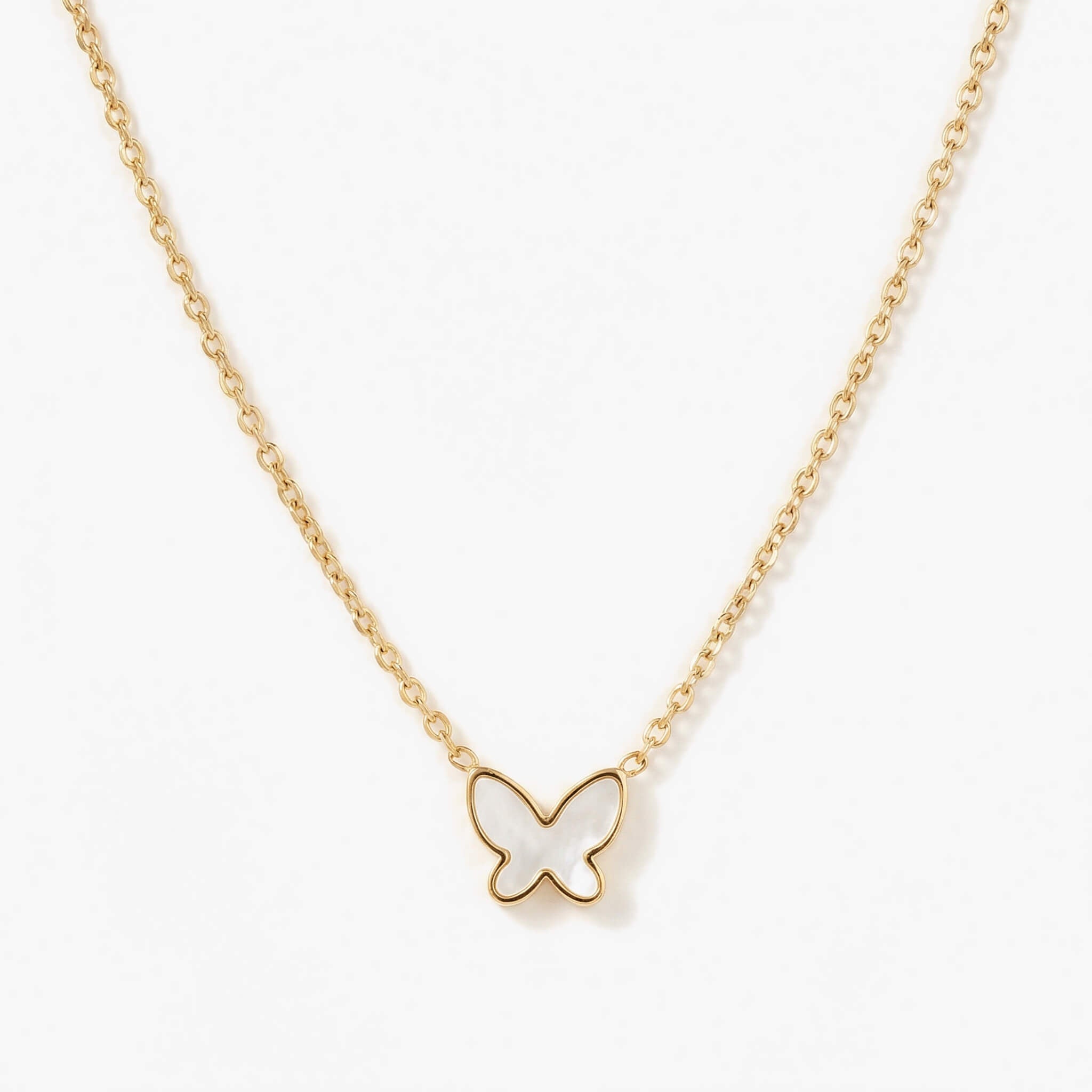 New Season Butterfly Necklace gold chain and mother-of-pearl pendant, close-up on white