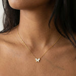 New Season Butterfly Necklace – worn at the collarbone, gold, white butterfly pendant, bare neckline