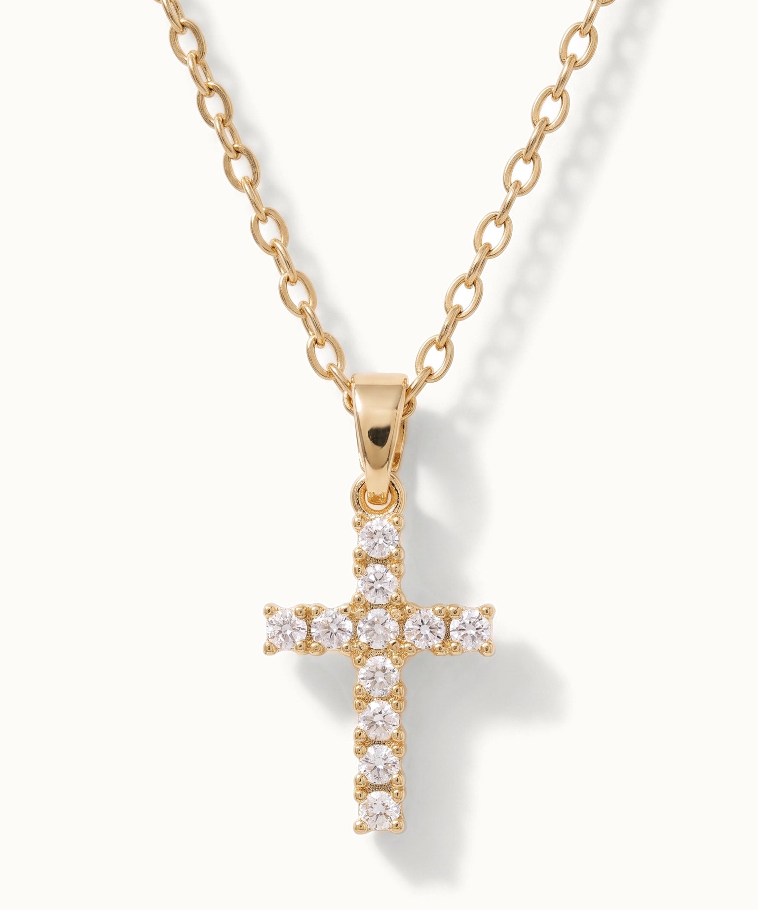 Radiant Cross Necklace in gold, close-up of the stone-set cross