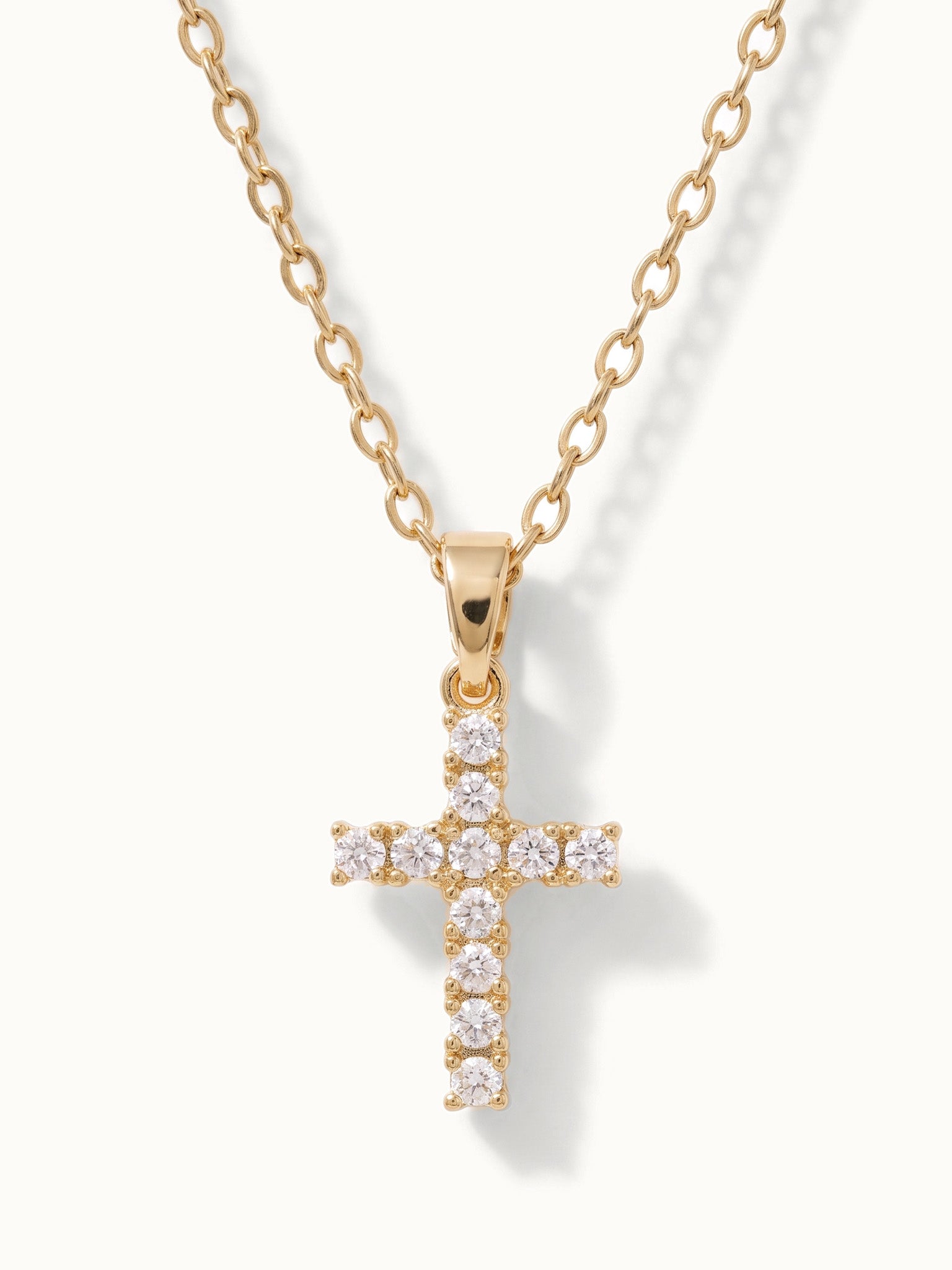 Radiant Cross Necklace in gold, close-up of the stone-set cross
