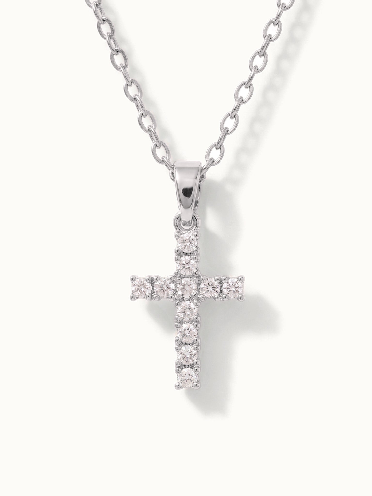 Radiant Cross Necklace in silver, close-up of the stone-set cross, alternative framing