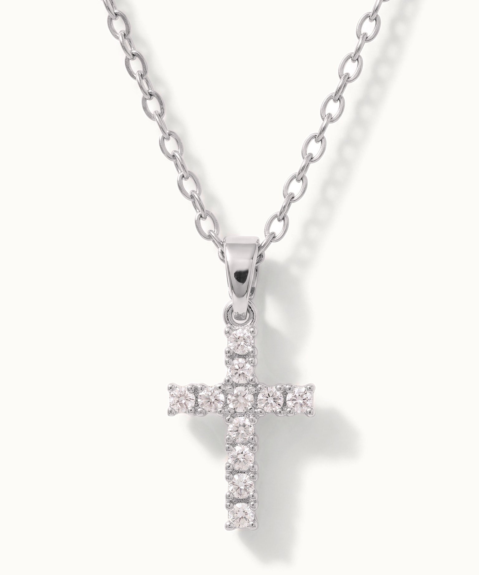 Radiant Cross Necklace in silver, close-up of the stone-set cross