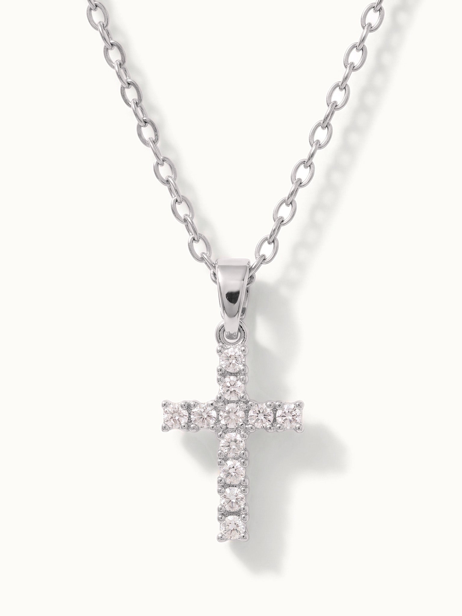 Radiant Cross Necklace in silver, close-up of the stone-set cross
