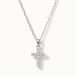 Radiant Cross Necklace in silver, hanging on a fine chain, alternative framing