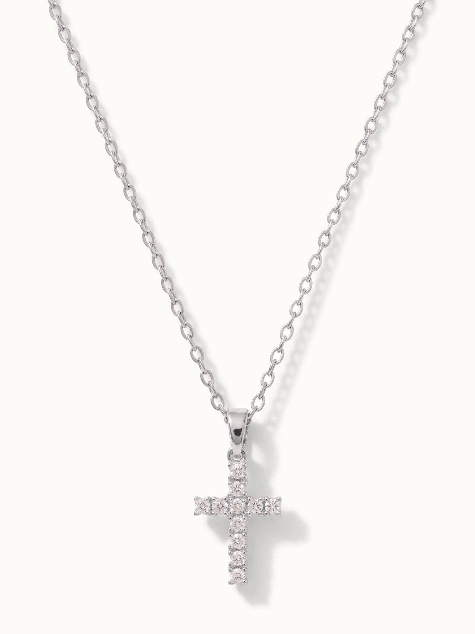 Radiant Cross Necklace in silver, hanging on a fine chain