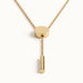 Rising Lariat Necklace – lariat hanging straight with disc slider and bar drop, gold, on ivory background