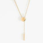 Rising Lariat Necklace – lariat hanging straight, disc and bar drop, gold, on white background