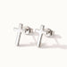 Rooted Cross Studs – pair of cross studs, silver, on ivory background